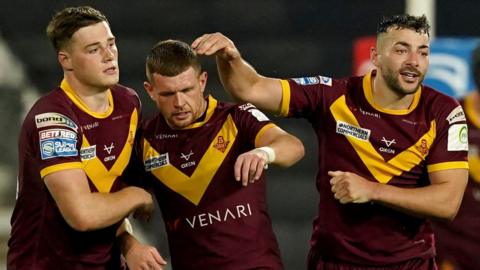 Oliver Russell (centre) sealed Huddersfield's victory over Hull FC with a drop-goal