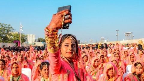 - A Muslim bride takes a selfie with her mobile phone as she participates in an 'All Religion Mass Wedding' ceremony at Sabarmati Riverfront in Ahmedabad on February 8, 2020. (P