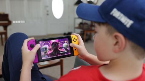 A boy playing on a Nintendo Switch