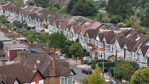 File image of a row of homes on a suburban street in Ealing