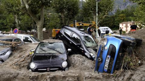 This general view shows a pile of vehicles on a street in Breil-sur-Roya, south-eastern France