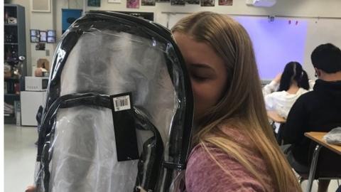 Student returning to Marjory Stoneman Douglas High in the US with a clear backpack - part of a new policy to combat school shootings, 2 April 2018