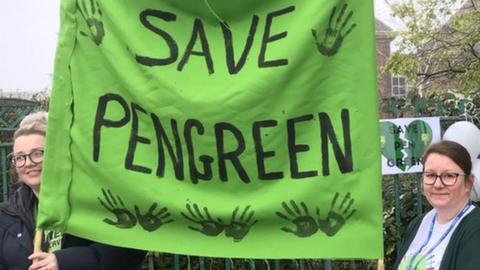 Pen Green nursery protest, parents and people holding a banner