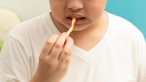 A child eats a fry
