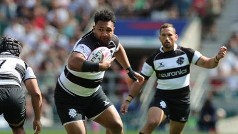 Sione Vailanu of the Barbarians runs with the ball