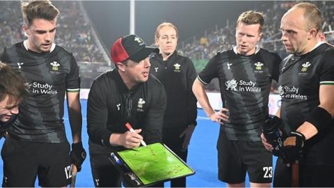 Wales head coach Danny Newcombe talks to his players