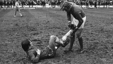 A player goes down with cramp during the 1970 FA Cup final