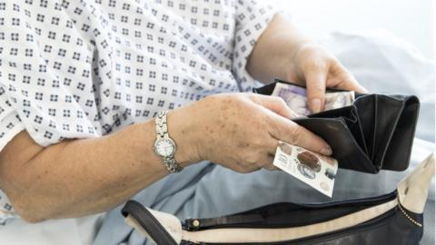 Female patient handing over money