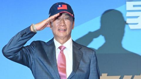 Former Foxconn Founder Terry Gou salutes during a press conference in Taipei on August 28, 2023.