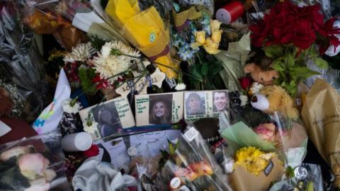 Photos of the victims from last weeks shooting are seen at the memorial outside of Oxford High School on December 7, 2021 in Oxford, Michigan