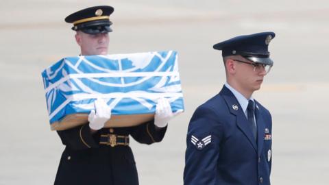 Soldiers carrie caskets containing remains of US soldiers who were killed in the Korean War during a ceremony at Osan Air Base in Pyeongtaek, South Korea, 27 July 2018.