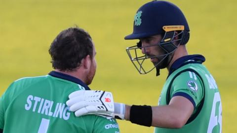 Paul Stirling is congratulated by Andrew Balbirnie after bringing up his century against England