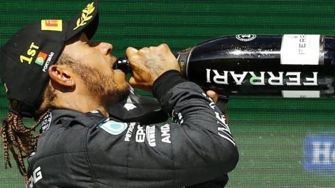 Lewis Hamilton drinks champagne