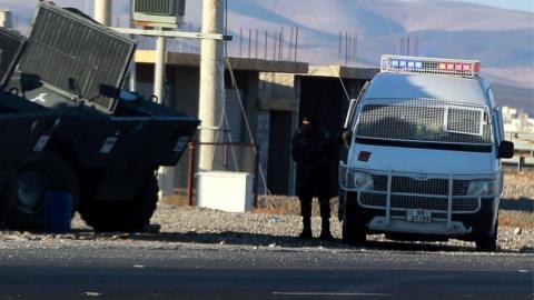 Jordanian police forces deployed on a desert road near Maan, southern Jordan, 16 December 2022