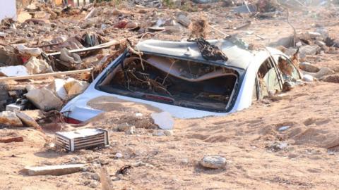Damaged vehicle is stuck debris after the floods caused by the Storm Daniel ravaged disaster zones in Derna, Libya on September 12, 2023