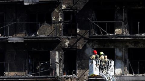 Firefighters work at the scene of a fire on an apartment building in Valencia, Spain, February 23, 2024