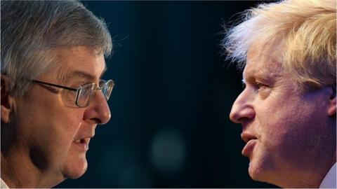 Mark Drakeford and Boris Johnson facing one another