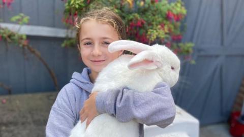 Rabbit being held by Rosie