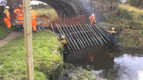 Dam being installed in canal