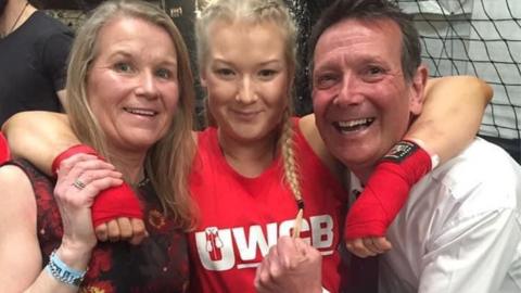 Bronwyn Morgan with her parents at a charity boxing event