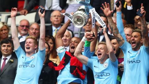 Man City captain Vincent Kompany lifting the FA Cup in Wembley's Royal Box