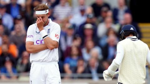 Stuart Broad (left) with his head in his hands after Jasprit Bumrah hits him for 35 runs from one over