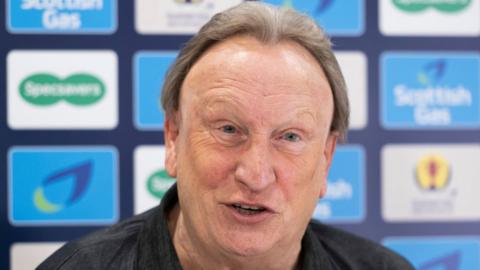 Aberdeen manager Neil Warnock speaks at a media conference