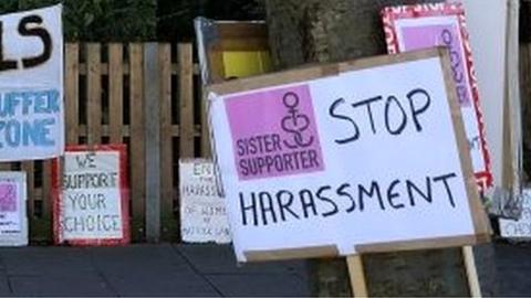 Signs calling for an end to vigils outside a clinic in Ealing