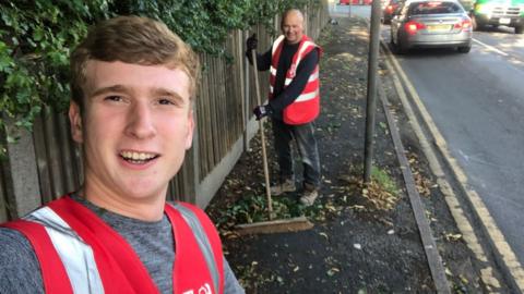 Matthew Lock sweeping street with fellow Labour councillor Ken Hughes