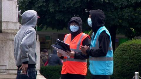 Bolton council workers giving out masks