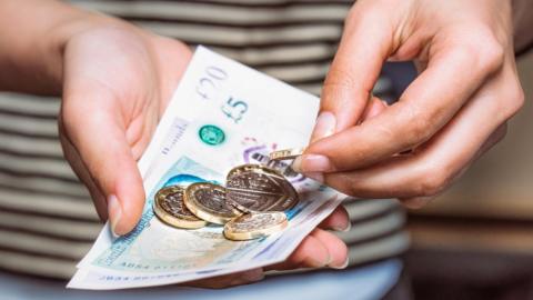 Woman counts money in her hands