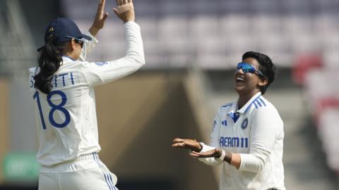 India players Smriti Mandhana (left) and Deepti Sharma (right) celebrate a wicket v England