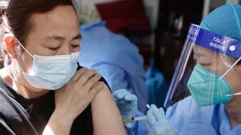 Woman receiving a booster jab at a clinic in Shanghai