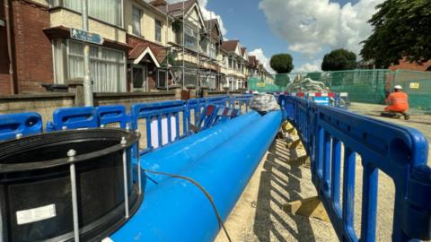 New pipework lies next to the excavation site