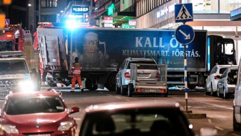 he truck (bottom, blue) that crashed into the Ahlens department store at Drottninggatan in central Stockholm