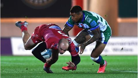 Ioan Nicholas of Scarlets is tackled by Monty Ioane of Benetton
