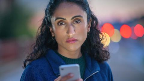 Charanpreet Khaira looking at her phone