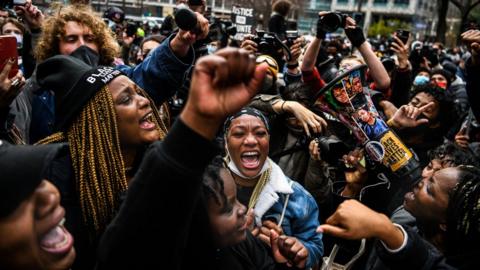 People celebrate as the verdict is announced in the trial of former police officer Derek Chauvin outside the Hennepin County Government Center in Minneapolis, Minnesota on 20 April 2021