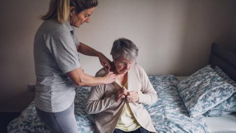 Elderly woman receiving home help