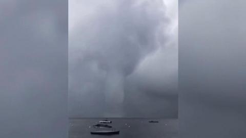 Video shows a whirling waterspout, which is similar to a tornado, forming on Sebago Lake in the US.