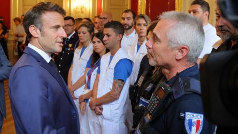 French President Emmanuel Macron meets rescuers in Annecy