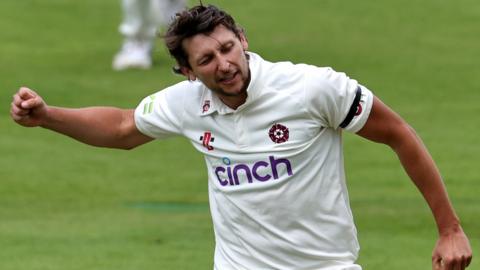 Northants bowler Jack White celebrates a wicket