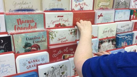 Shop manager sorting Christmas cards in Card Factory