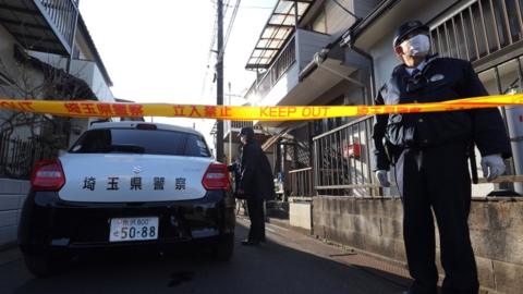 Police and other responders outside the suspect's home on Friday