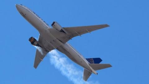 United Airlines flight UA328 can be seen with flames coming from its engine