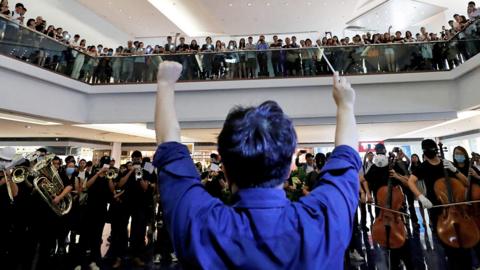 A group of music performers plays a protest song "Glory to Hong Kong" during a protest inside a shopping in Hong Kong