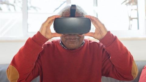 An elderly person wearing a VR headset