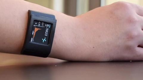 A person wearing a device which measures cortisol in the wearer's sweat