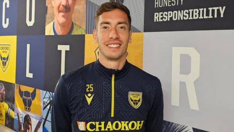 Oxford United's Alex Rodriguez-Gorrin smiles in his kit at the U's facility.