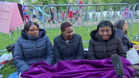 Royal Family fans endure a chilly night and damp morning to get a glimpse of Prince Harry and Meghan Markle.